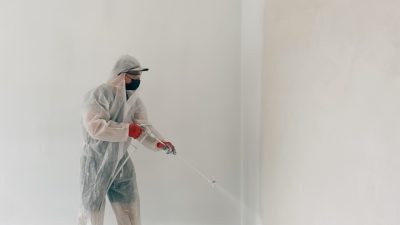 man-paints-walls-with-a-paint-sprayer-2025-01-09-03-22-50-utc